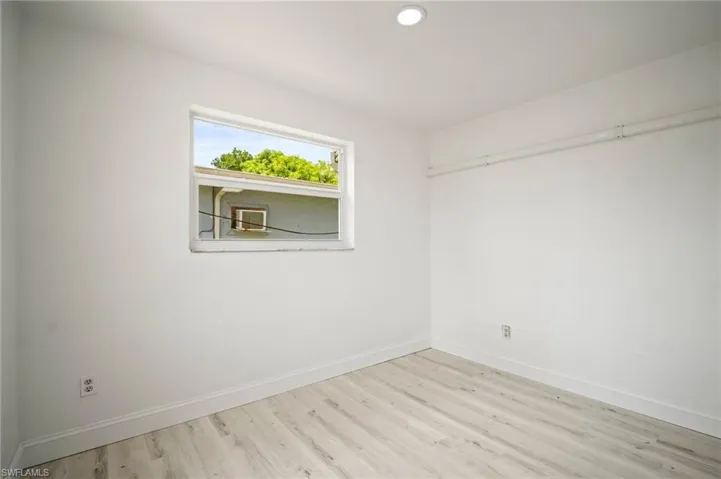 Empty room with wood finished floors and recessed lighting