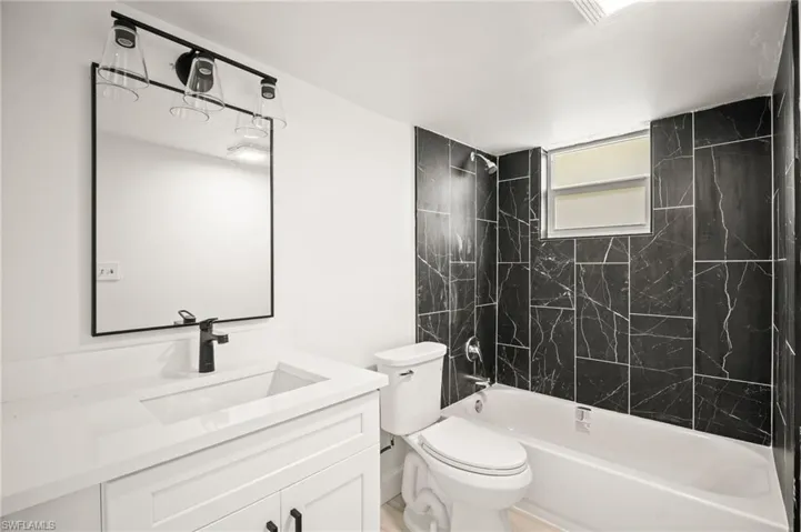 Bathroom with shower / bathtub combination and vanity