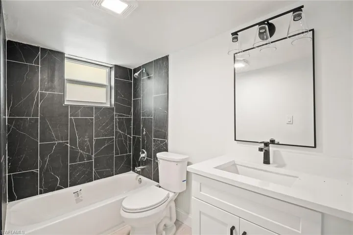 Bathroom with vanity and shower / tub combination