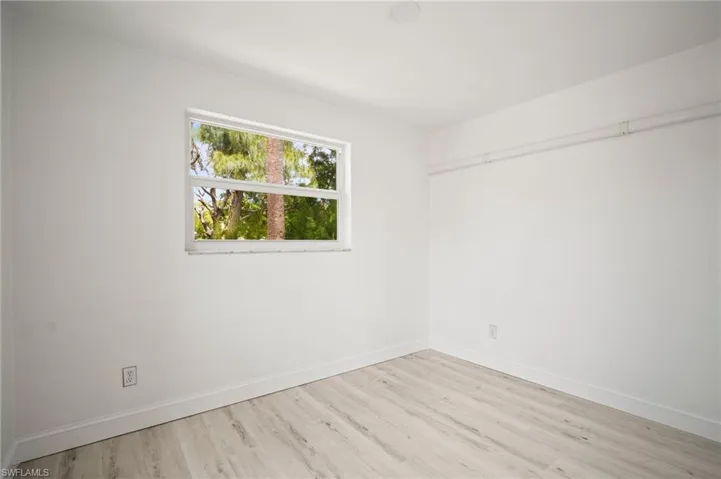 Unfurnished room with wood finished floors