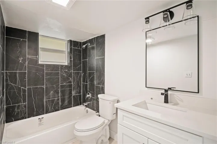 Full bath with vanity and shower / bath combination
