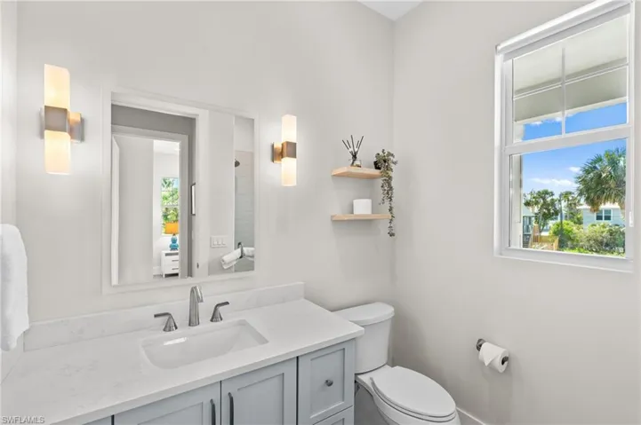 Bathroom with toilet and vanity, virtually edited photo