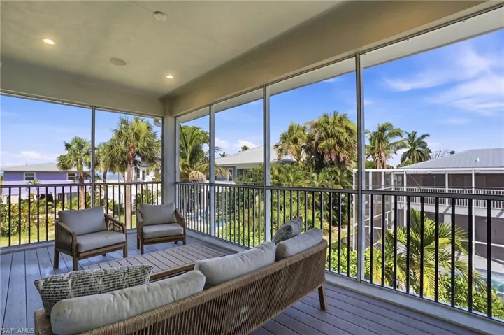 Screened in balcony with outdoor lounge area. virtually edited photo
