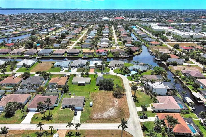 View of property location with a large body of water and nearby suburban area