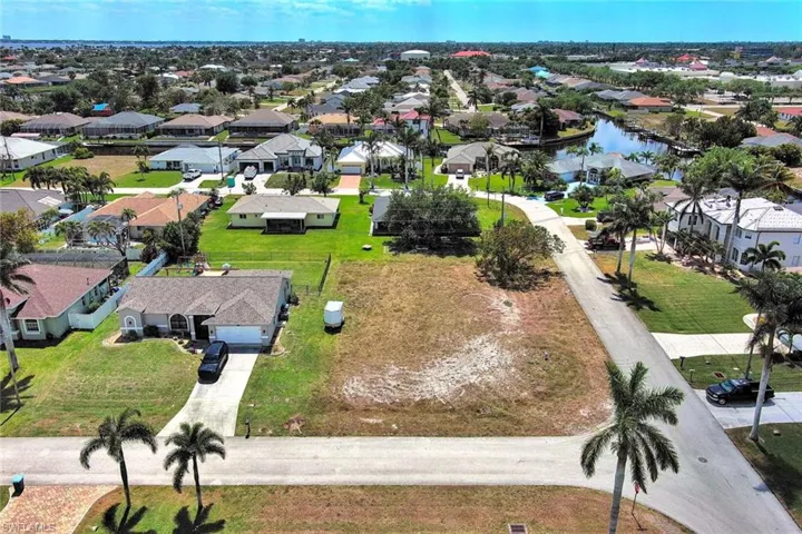 Aerial view of residential area featuring a large body of water
