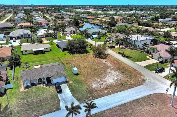 Aerial perspective of suburban area featuring a large body of water