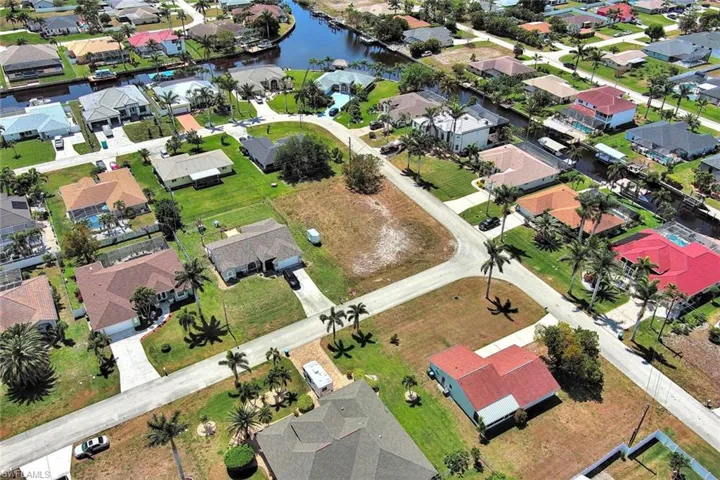 Aerial view of residential area featuring a large body of water