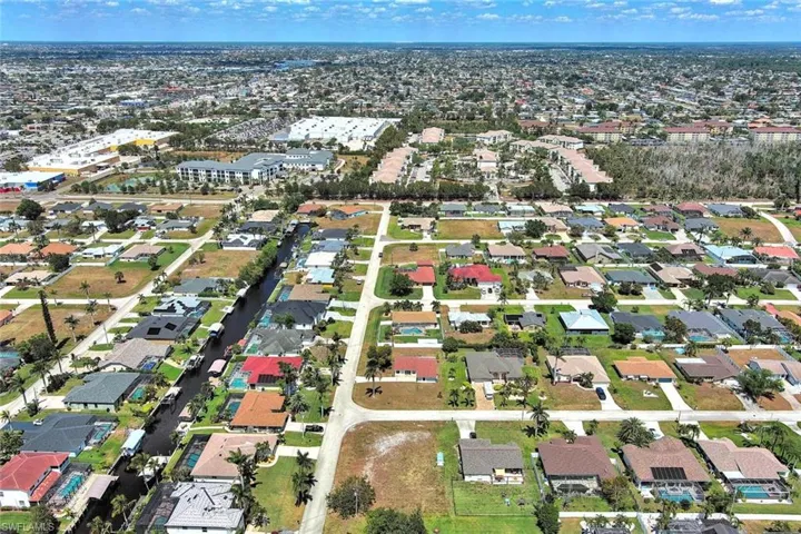 Aerial overview of property's location featuring nearby suburban area
