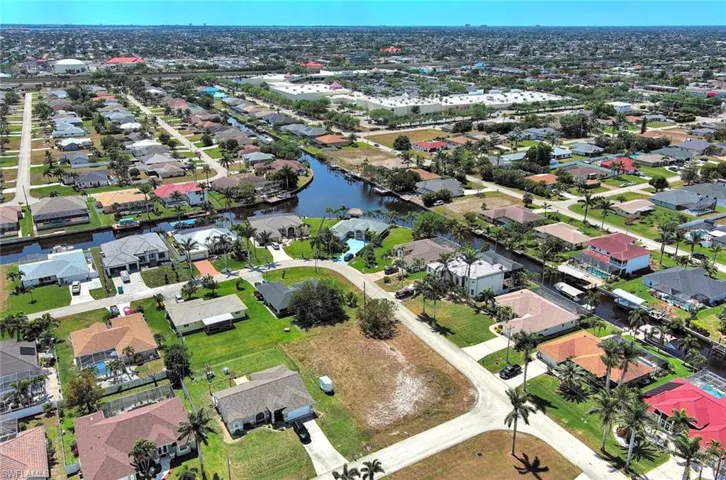 Aerial view of property's location with nearby suburban area and a nearby body of water
