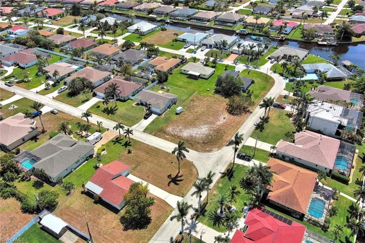 Aerial perspective of suburban area with a large body of water