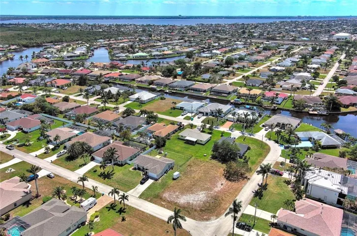 View of property location with a large body of water and nearby suburban area