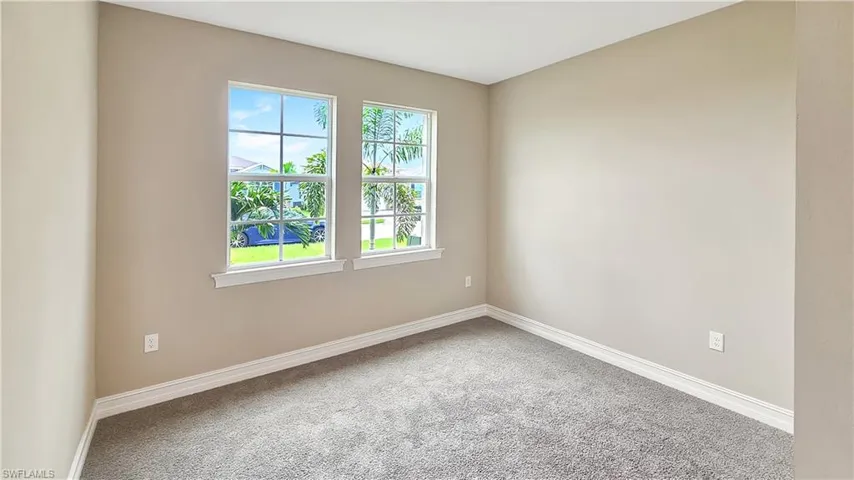Carpeted spare room with a healthy amount of sunlight