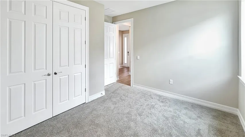 Unfurnished bedroom with a closet and carpet flooring