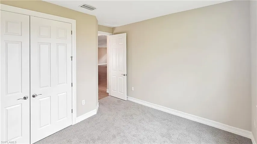 Unfurnished bedroom with a closet and carpet flooring