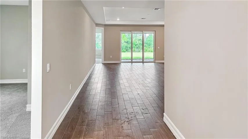 Hallway featuring carpet