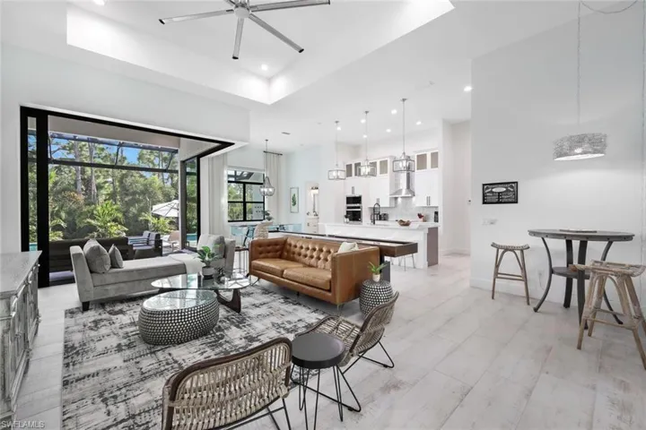 Living room with ceiling fan and a tray ceiling