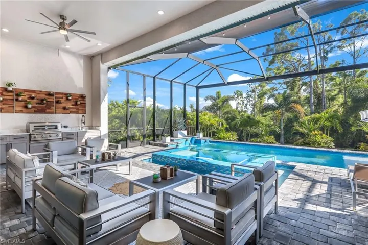 View of pool with ceiling fan, a grill, and sink