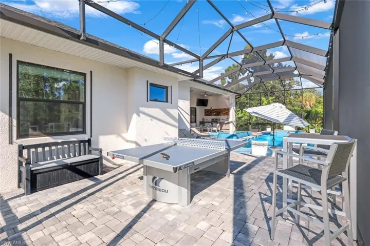 View of patio featuring glass enclosure