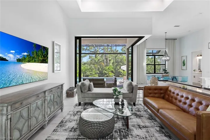Living room with light hardwood / wood-style flooring and a chandelier