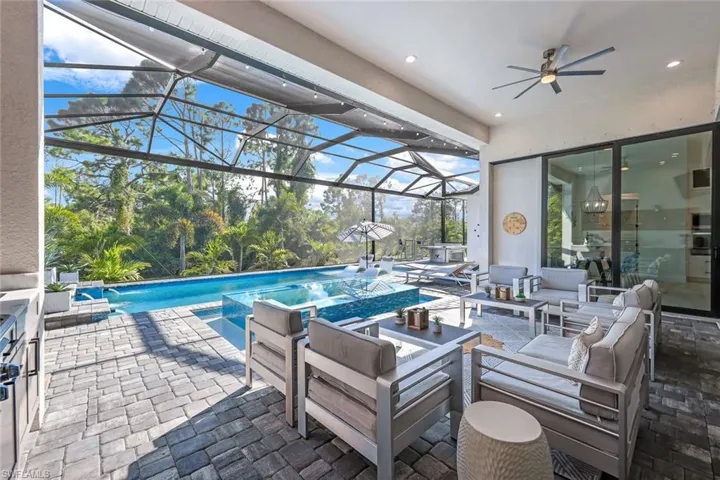 View of patio / terrace with a lanai, ceiling fan, and outdoor lounge area