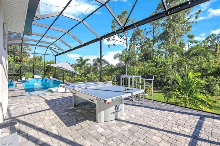 View of patio featuring glass enclosure