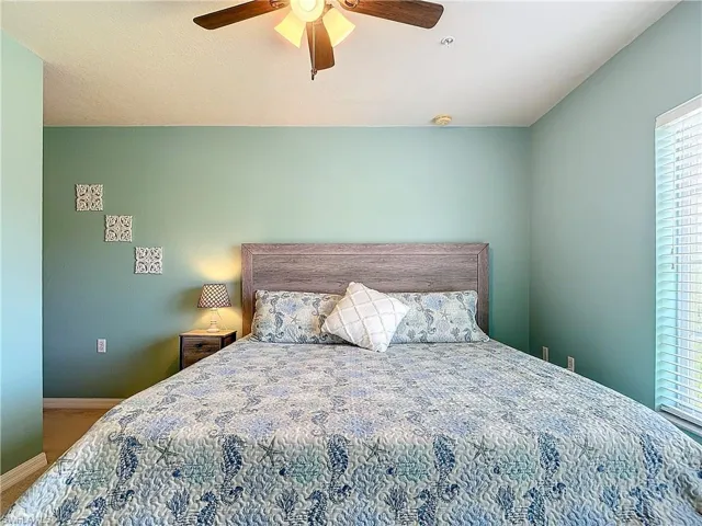 Carpeted bedroom with ceiling fan
