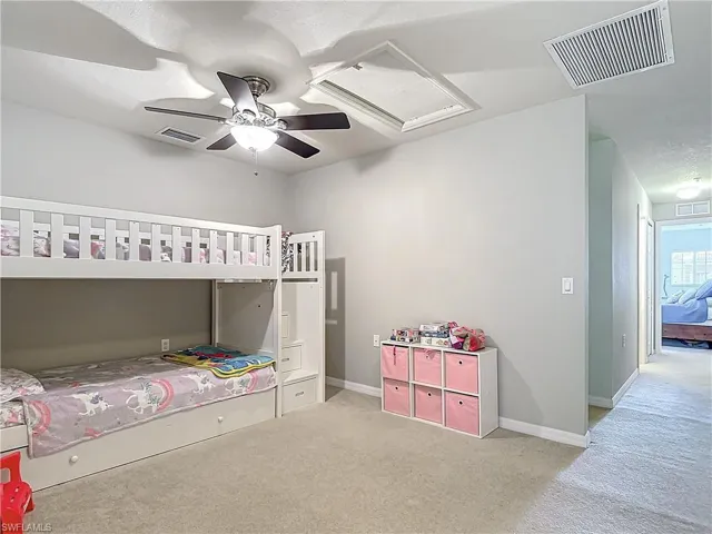 Carpeted bedroom with ceiling fan