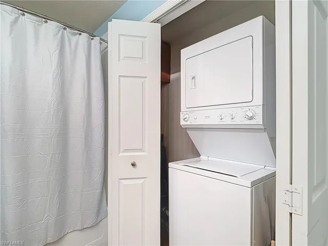 Laundry area featuring stacked washer and clothes dryer