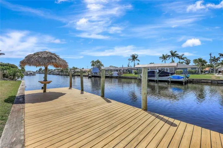 Dock area with a residential view and a water view