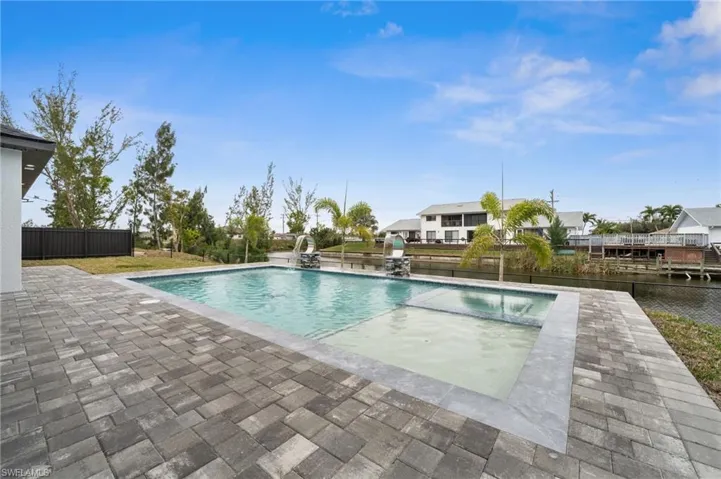Large pool with spa, sun deck and fountains.