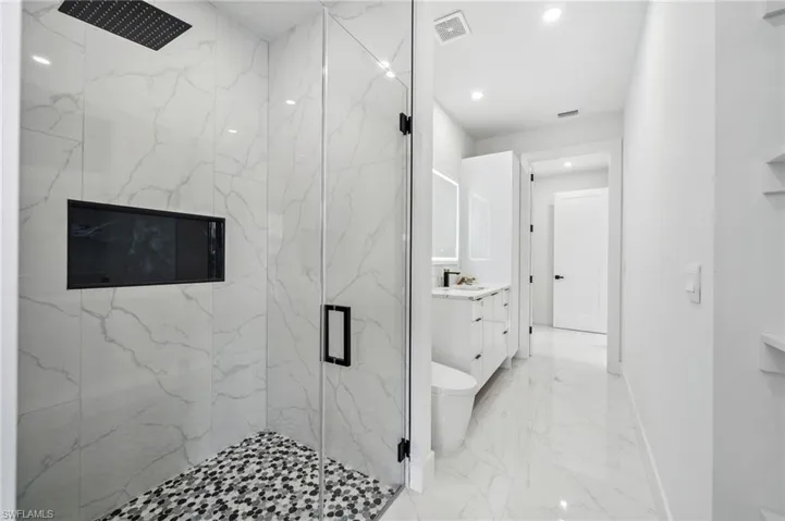 Main Bathroom with access to the pool and patio area.