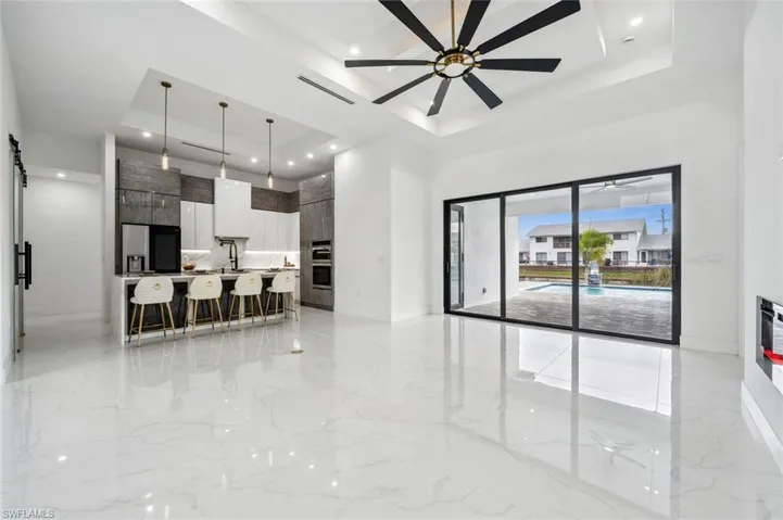 Open concept kitchen and living area with view of the pool.