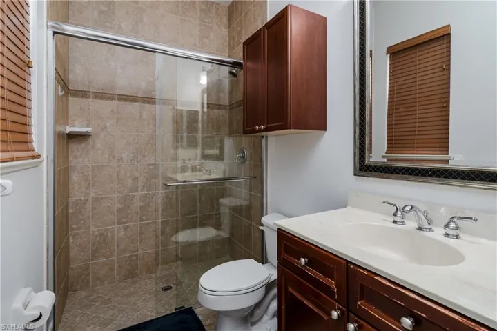 Full bathroom featuring vanity and a stall shower