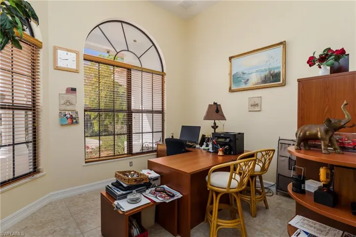 Office area with baseboards and light tile patterned flooring