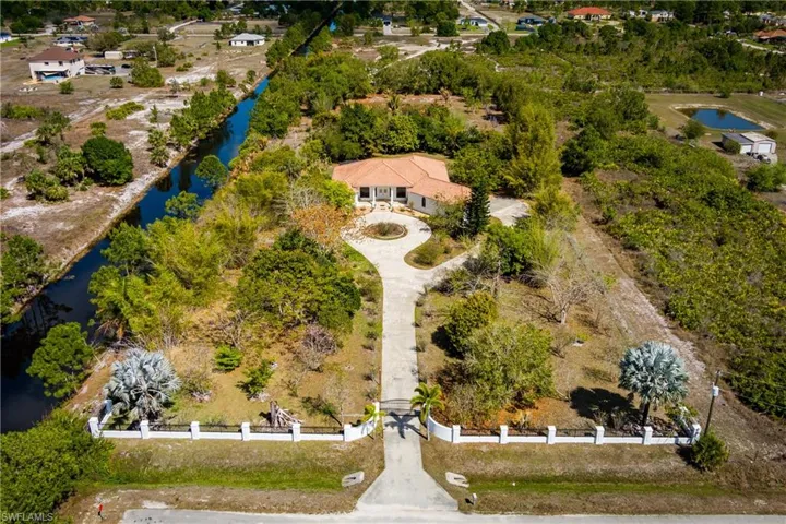 Drone / aerial view of a large body of water and a tree filled landscape