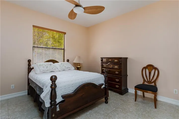 Bedroom featuring baseboards and ceiling fan
