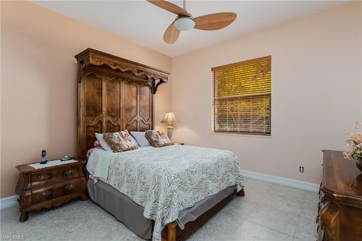 Bedroom featuring a ceiling fan and baseboards