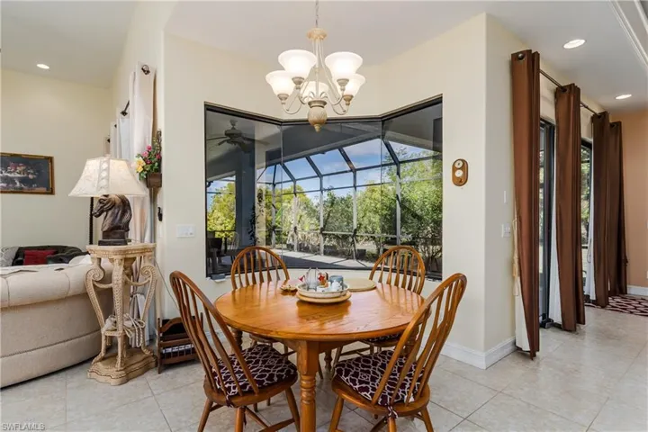 Dining room featuring a sunroom, healthy amount of natural light, and light tile patterned flooring
