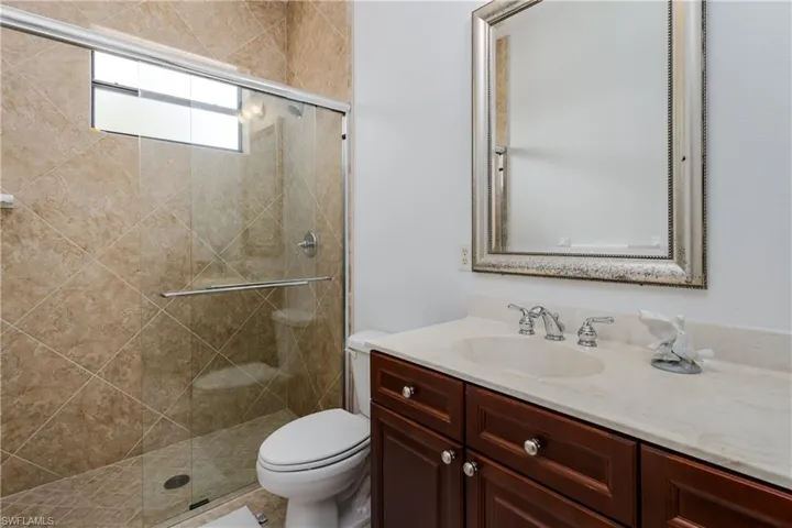 Full bathroom with vanity and a shower stall