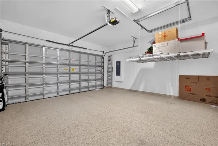 This retractable storage shelf is a lifesaver!!! No ladder required! Upgraded garage flooring.