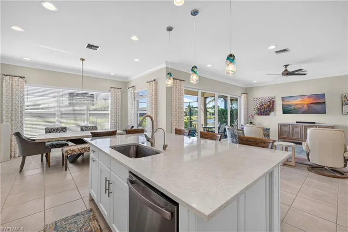 View from kitchen into great room, dining area and outside to take in the awesome lake view!
