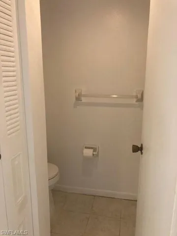 Bathroom featuring vinyl flooring and toilet