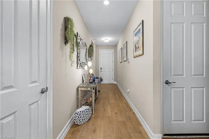 Corridor featuring baseboards and light wood-style flooring