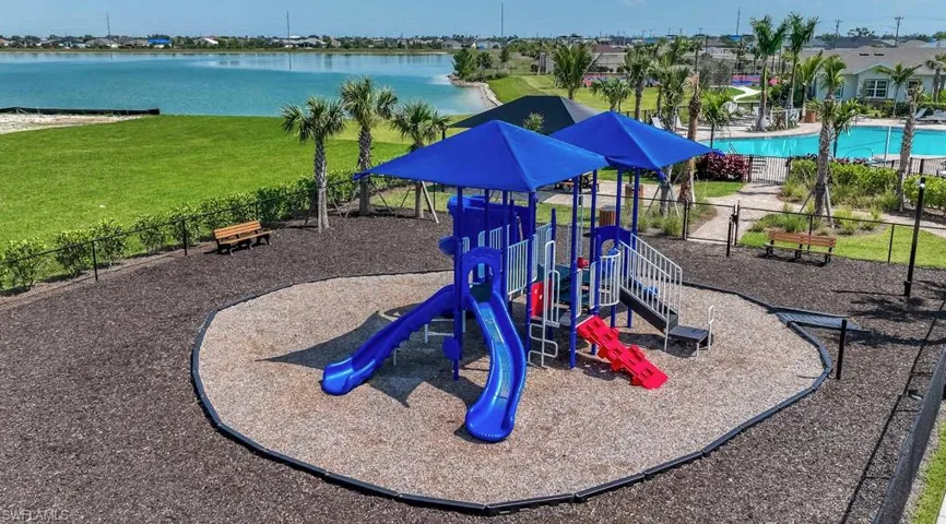 Community playground featuring a water view