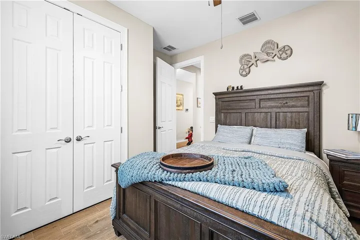 Guest Bedroom 2 featuring light wood finished floors and a closet
