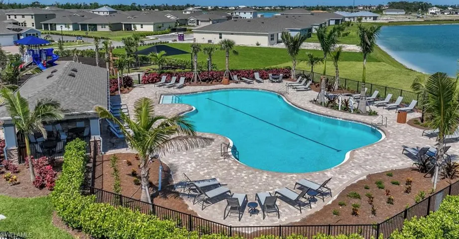 Community pool with a patio and a residential view