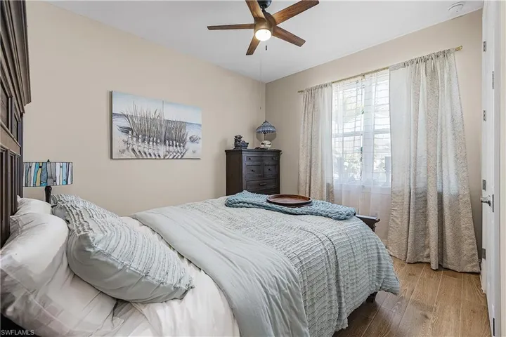 Guest Bedroom 2 featuring wood finished floors and ceiling fan