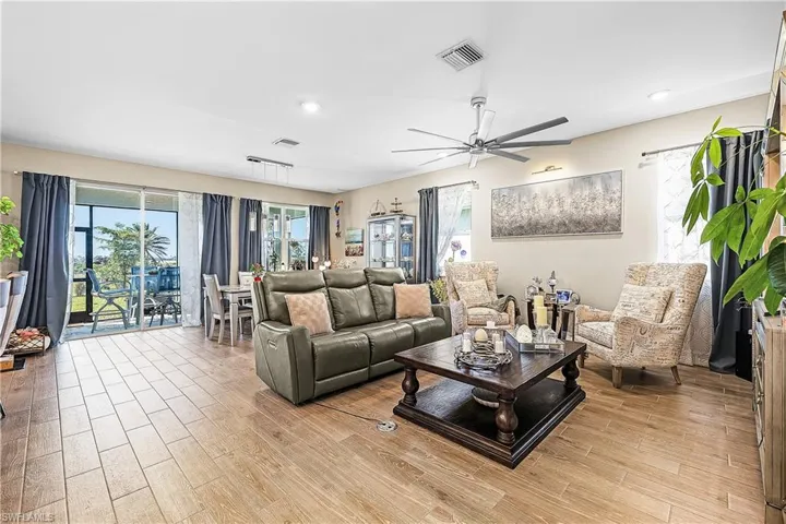 Living area featuring light wood-style flooring and a ceiling fan