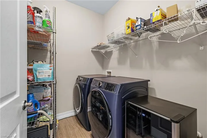 Laundry area featuring light wood-style floors and washer and clothes dryer