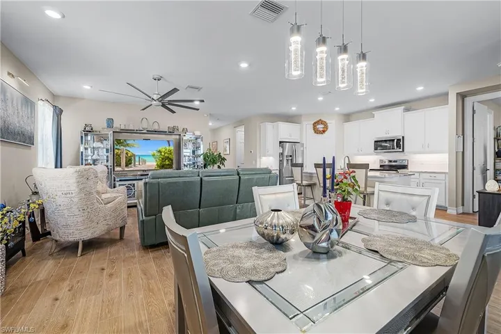 Dining area with light wood-style flooring, recessed lighting, and ceiling fan
